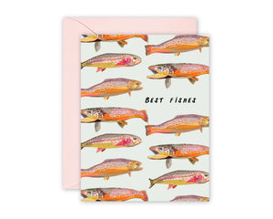 Greeting card with colorful illustrated rainbow and brown Colorado trout. Pale green background, pink envelope.