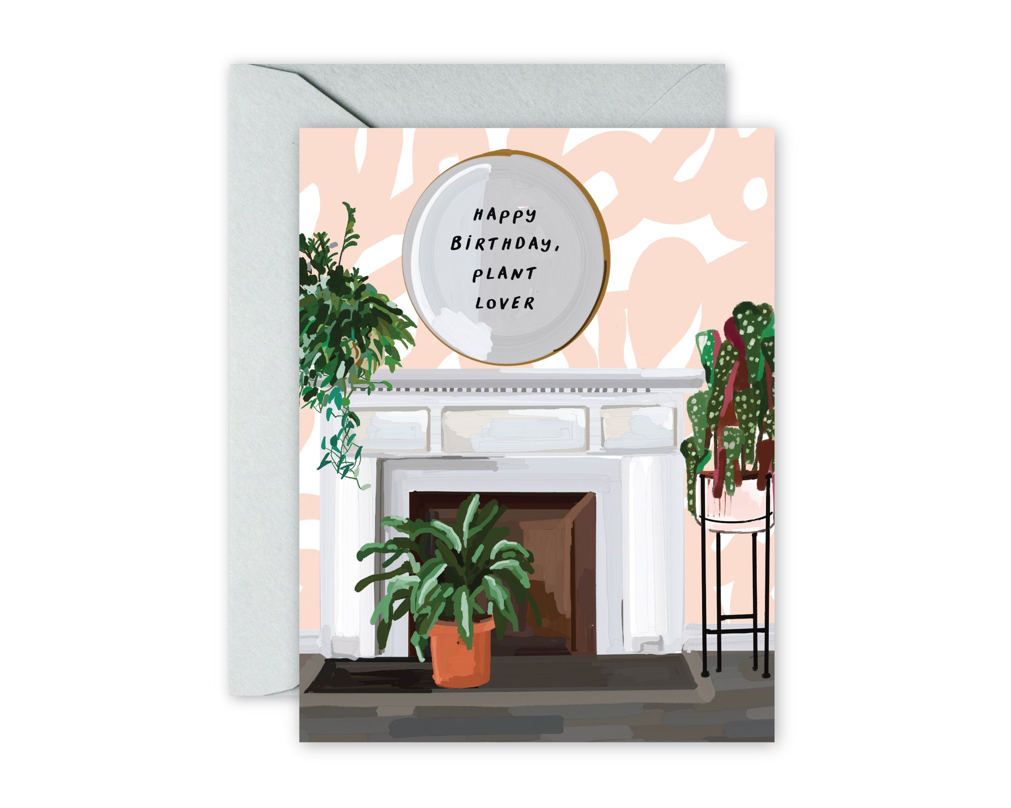 Greeting card with illustrated fireplace scene. Fireplace, pink swirl wallpaper, modern mirror with text overlay HAPPY BIRTHDAY, PLANT LOVER. Plants bordering fireplace. Grey envelope.