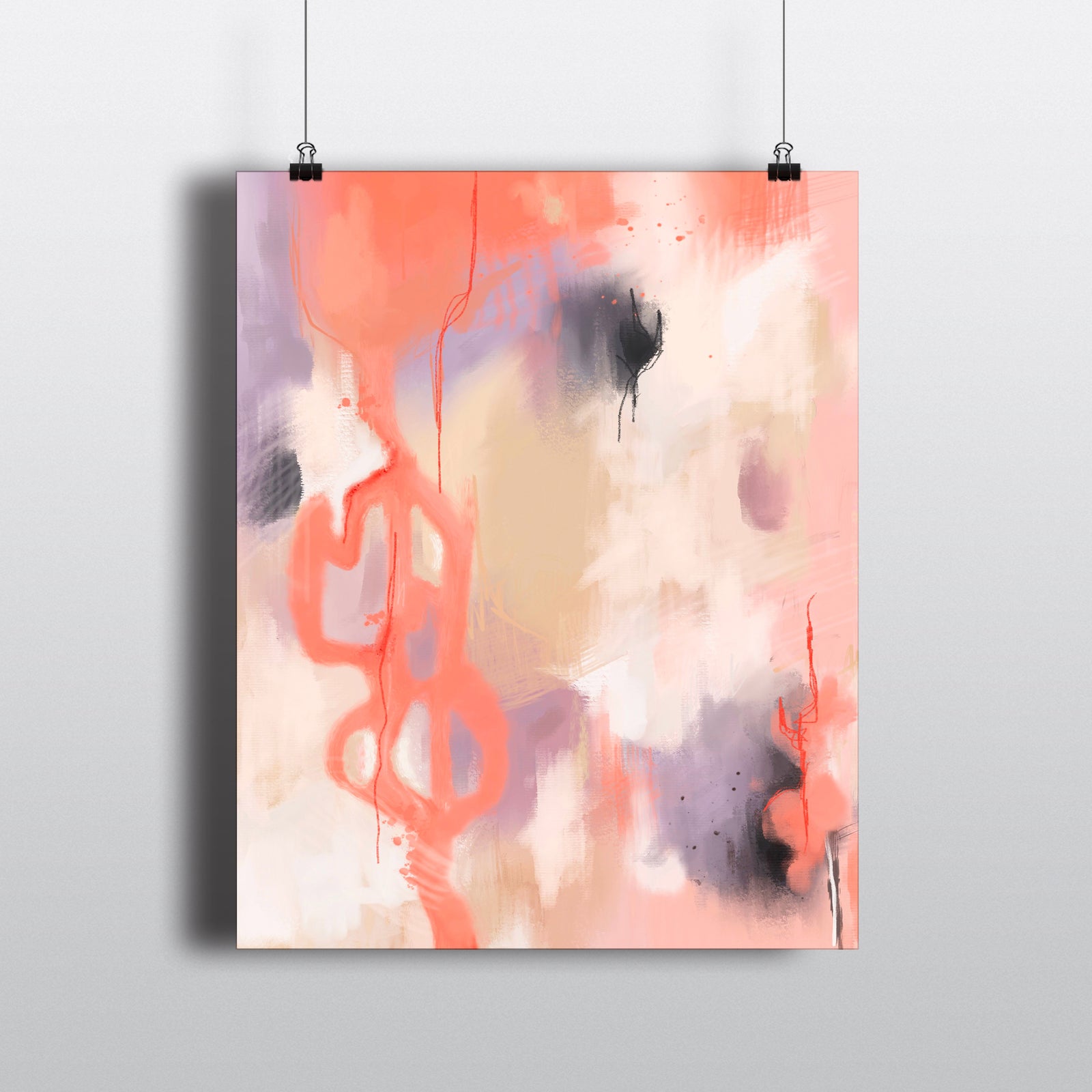 Abstract art print in shades of coral, tan and purple hanging from clips.