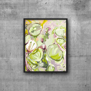 Floral abstract art print in shades of chartreuse lilac mauve and purples framed in black frame on grey wall