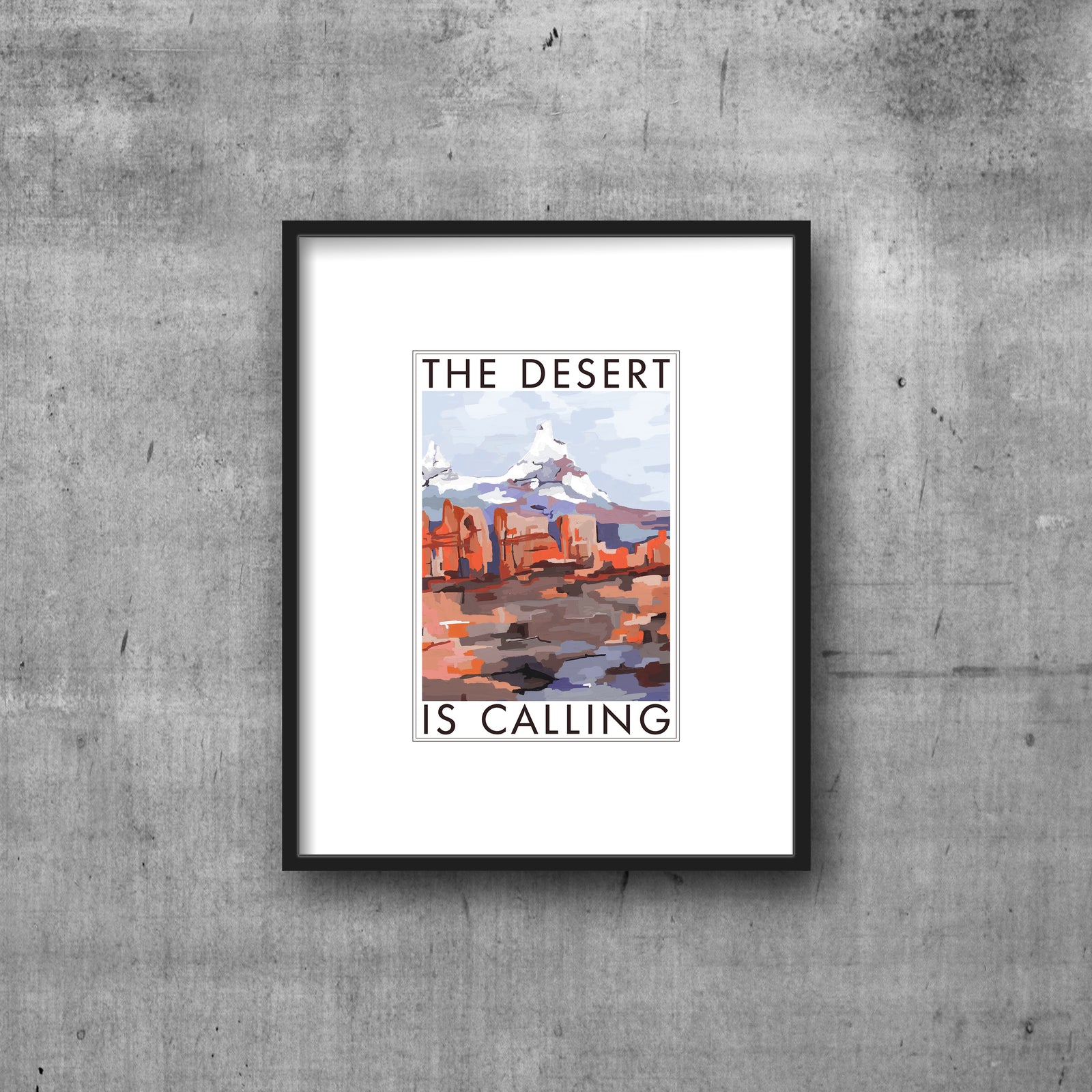 Art print with white border, THE DESERT IS CALLING text  framing abstract art of desert and mountain. Hanging by clips. 