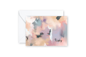 Abstract notecard in shades of tan, mauve, blue, purple with writing "Thanks", on white envelope